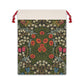 A rectangular Christmas-themed linen drawstring bag with a floral pattern, primarily in green and red colours, and a red drawstring at the top.