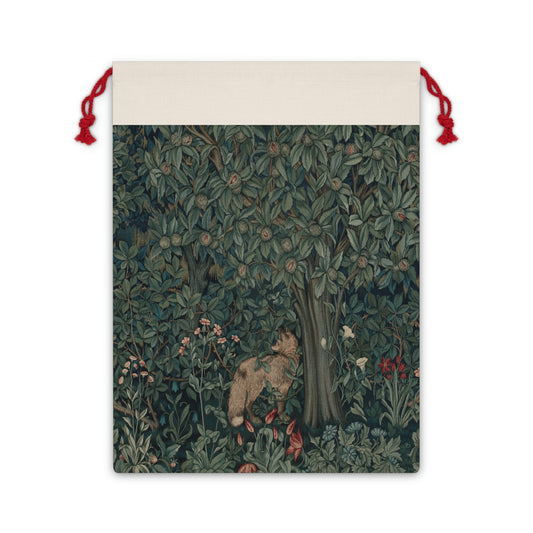 A Christmas-themed linen gift bag with a design inspired by the art of William Morris, featuring a green tree with leaves and red berries, and an embroidered 'Merry Christmas' greeting.