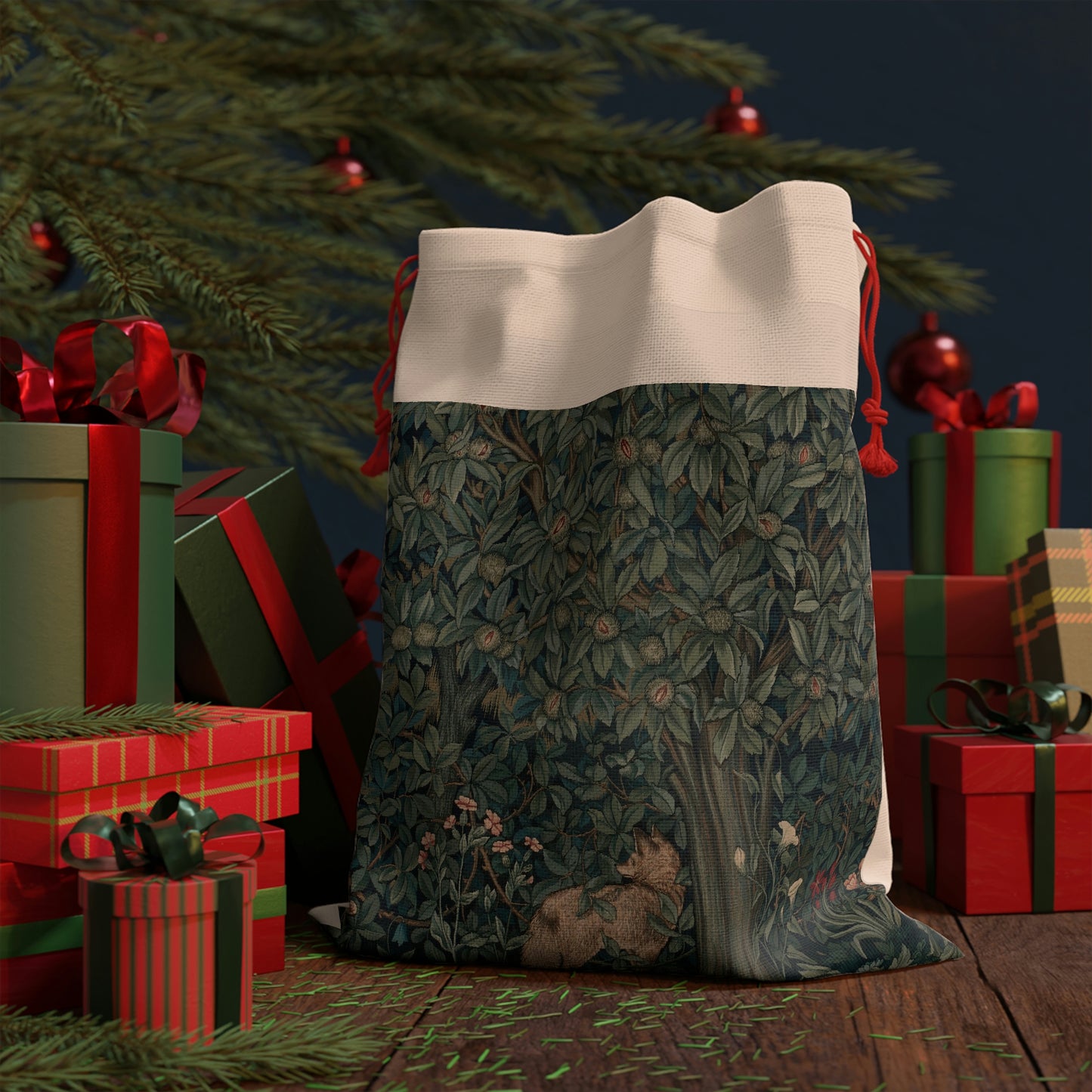 A Christmas-themed linen gift bag with a design inspired by the art of William Morris, featuring a green tree with leaves and red berries, and an embroidered 'Merry Christmas' greeting.