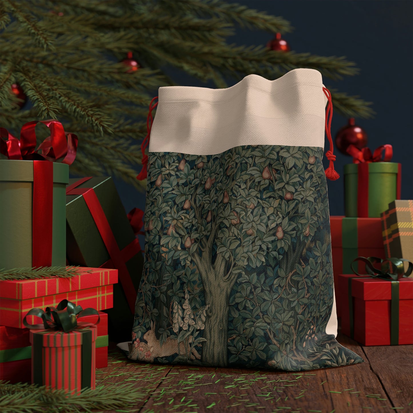 A Christmas-themed linen gift bag with a design inspired by the art of William Morris, featuring a green forest scene with a rabbit among the foliage.
