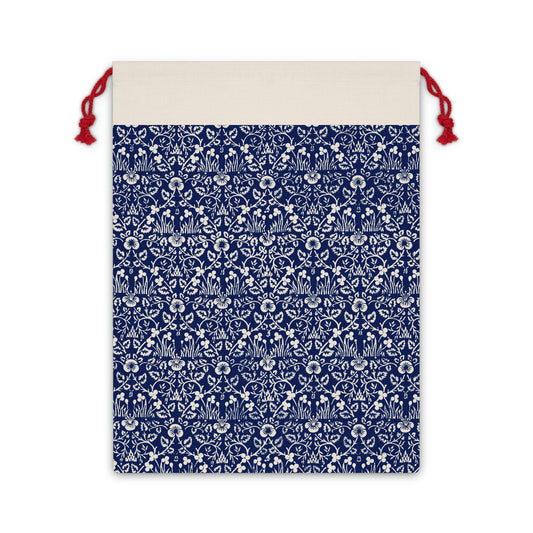 A beige linen drawstring gift bag with a blue floral pattern inspired by William Morris designs.