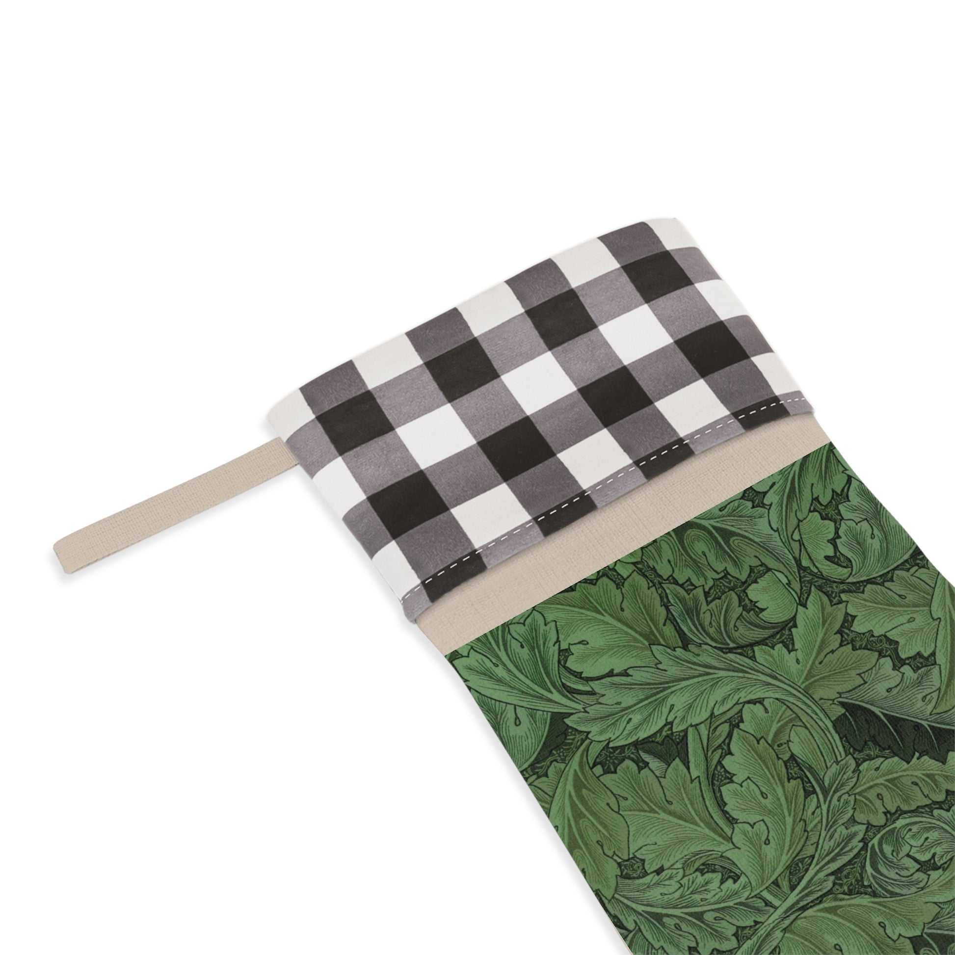 A green Christmas stocking with a black and white checkered top cuff and a wooden hanging loop in a William Morris & Co pattern.
