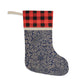 A one-sided print Christmas stocking with a geometric William Morris & Co floral pattern in blue, beige, and red colours, featuring a polyester plaid design top cuff and a wooden hanging loop.