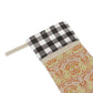 A one-sided print Christmas stocking with a red and black plaid design and a William Morris & Co floral pattern in orange and green tones. It has a beige background and a polyester cuff.