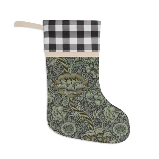 A one-sided print Christmas stocking with a black and white plaid design at the top and a floral pattern in the middle section, and a beige bottom cuff in a William Morris & Co pattern..