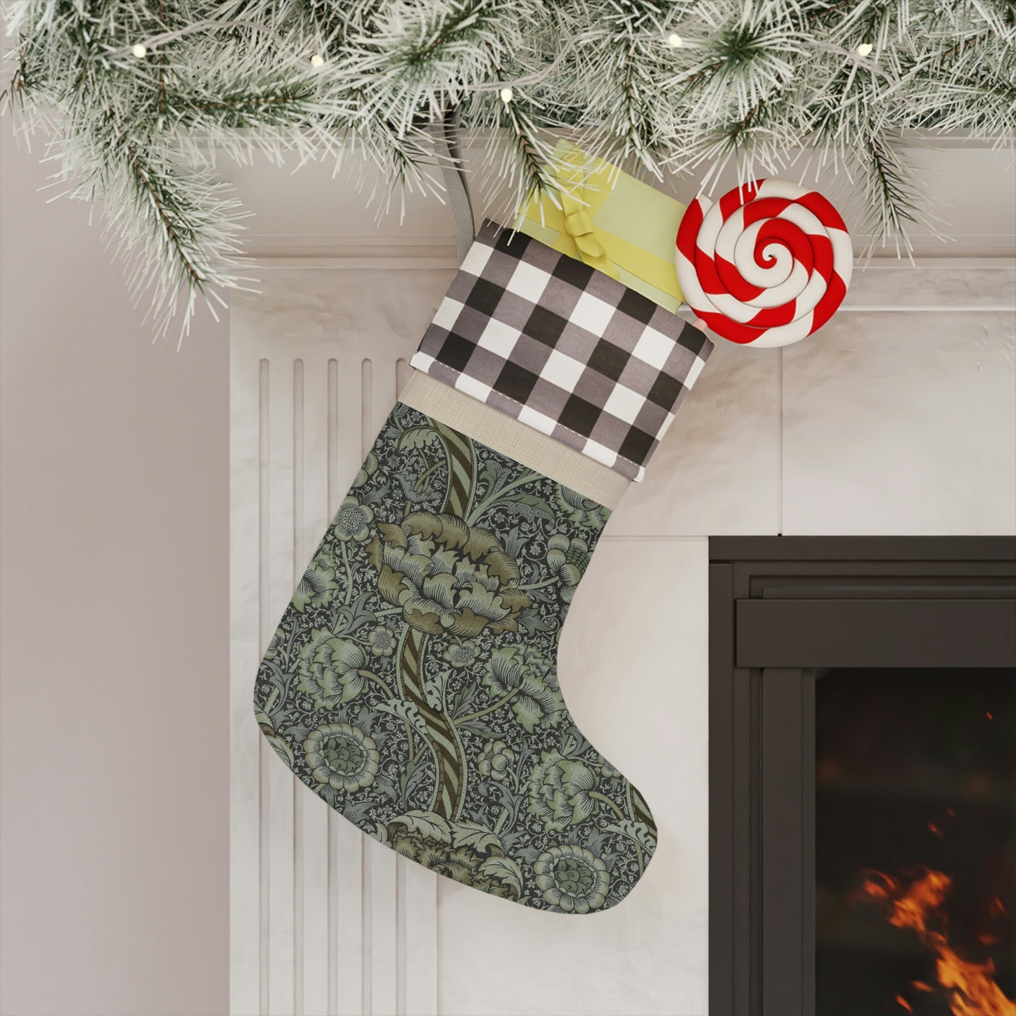 A one-sided print Christmas stocking with a black and white plaid design at the top and a floral pattern in the middle section, and a beige bottom cuff in a William Morris & Co pattern..