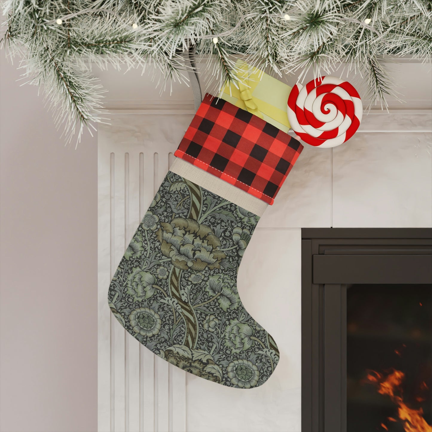 A one-sided print Christmas stocking with a black and white plaid design at the top and a floral pattern in the middle section, and a beige bottom cuff in a William Morris & Co pattern..