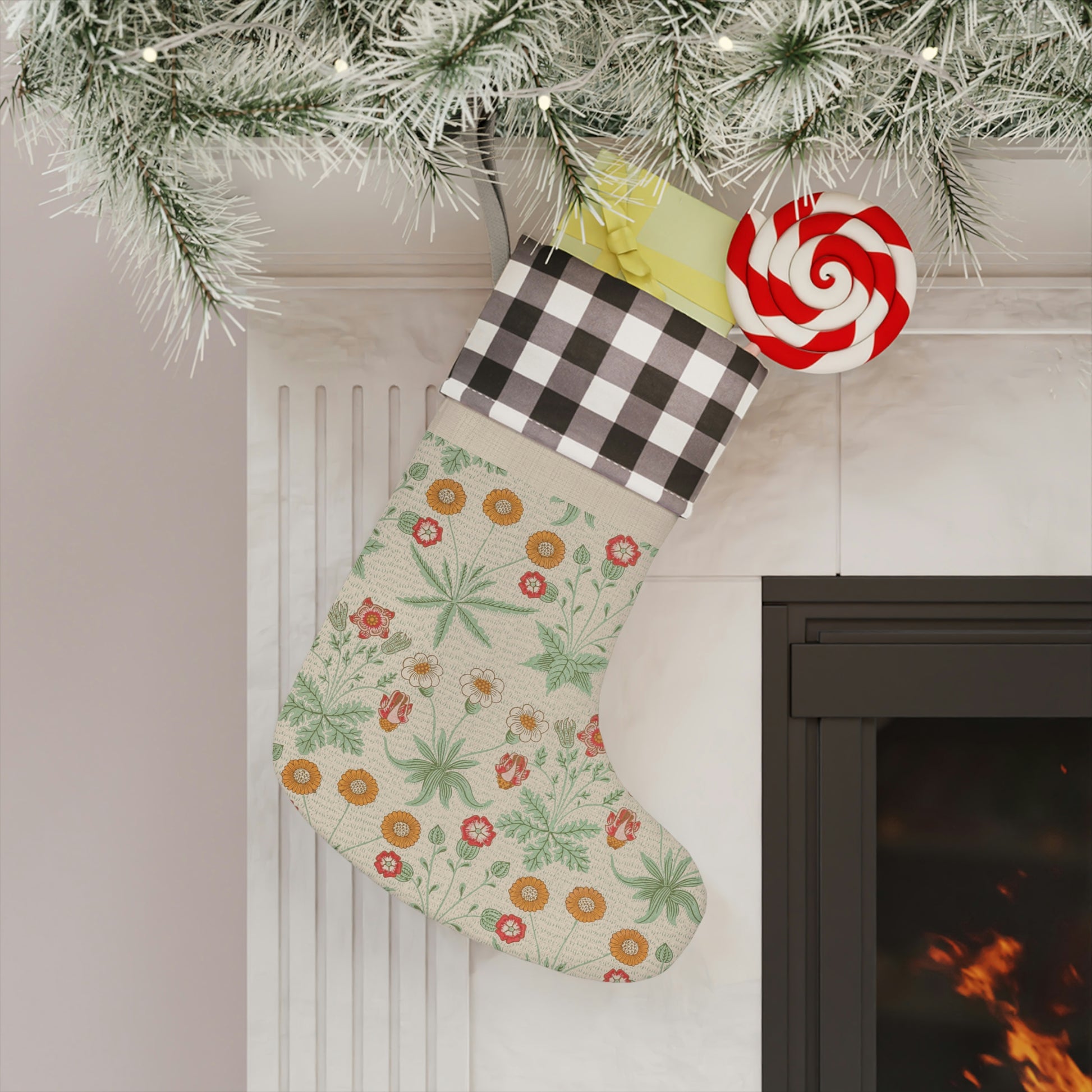 A Christmas stocking with a floral William Morris & Co pattern in red and green colours, featuring a red and black checkered cuff at the top.