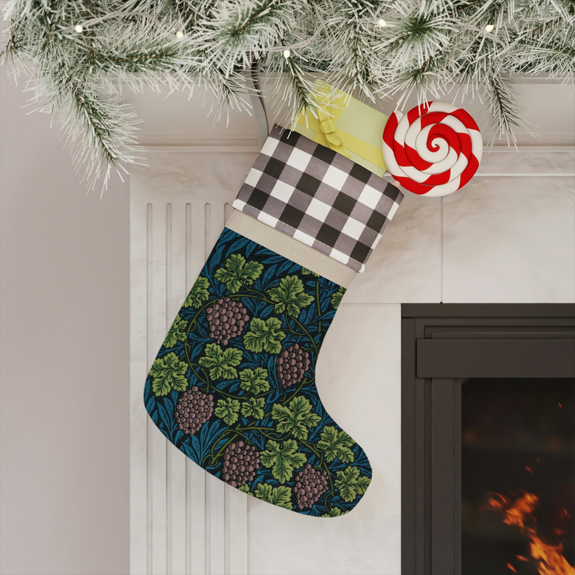 A one-sided printed Christmas stocking with a William Morris & Co floral vine design in shades of green, blue, and beige, featuring a black and white checkered cuff.