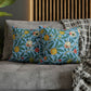 Cushion Cover in a floral pattern by William Morris & Co called Four Fruits Collection (Sky) in blue, green, red and yellow