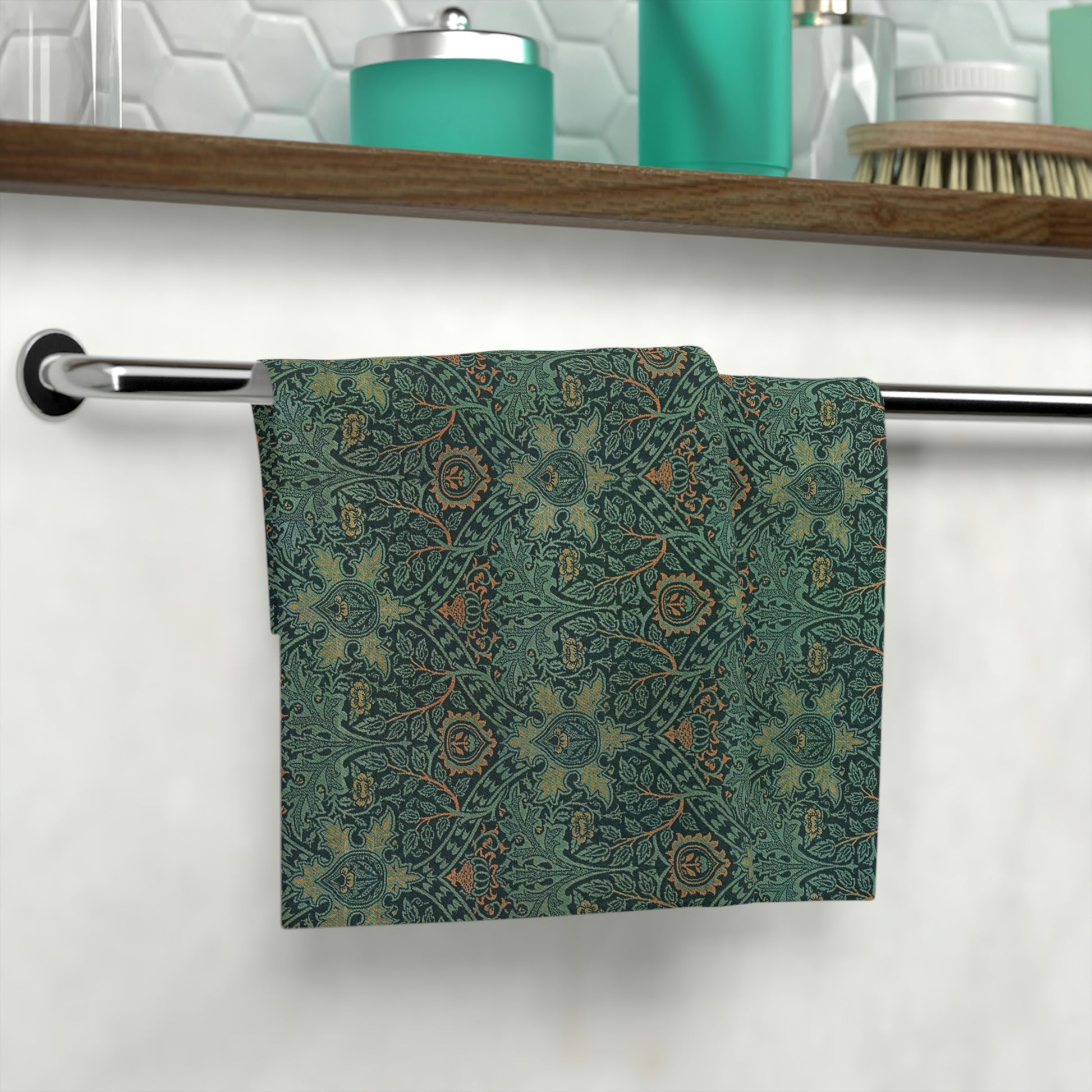 A face cloth with a floral pattern inspired by William Morris, hanging on a towel bar in a bathroom setting.