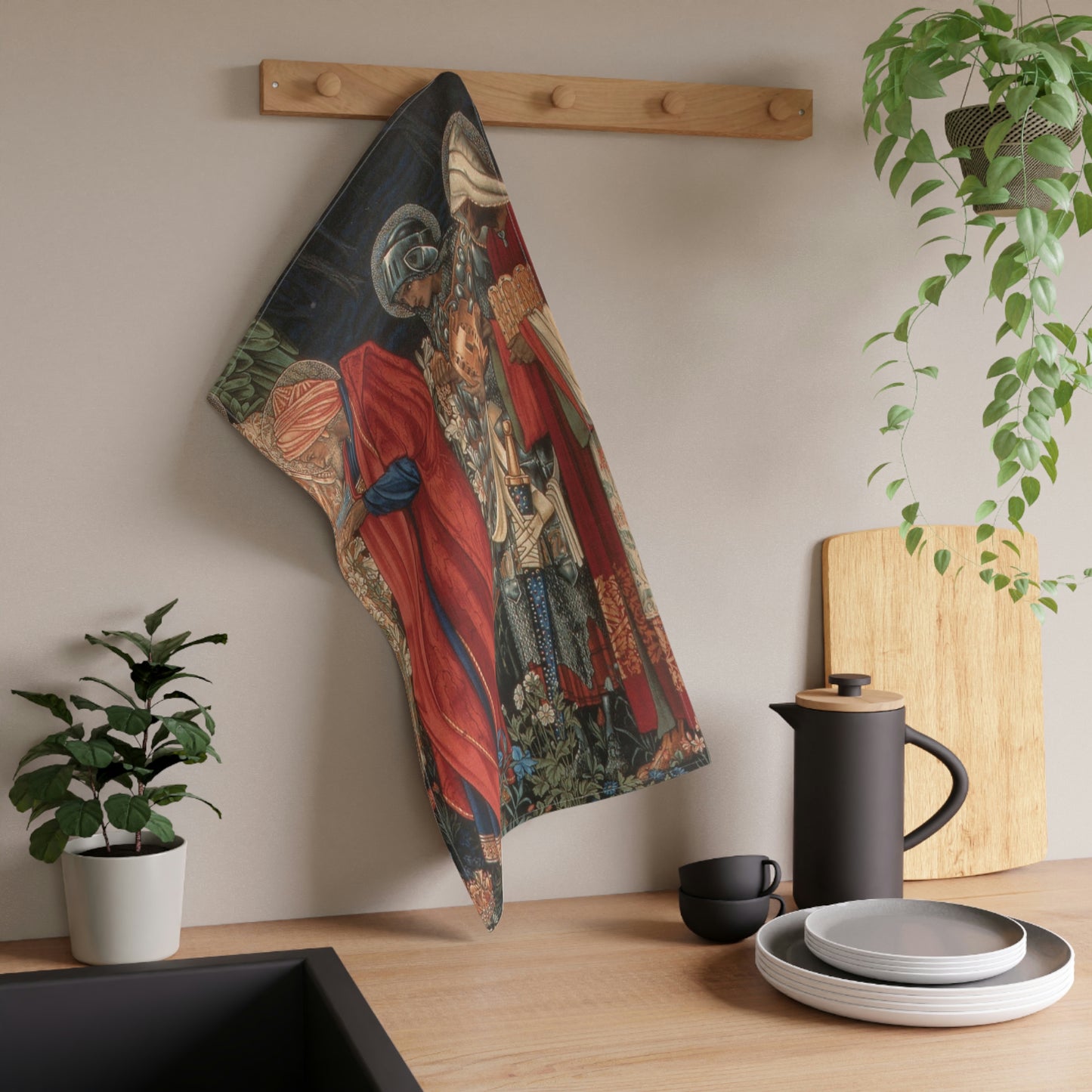 A kitchen tea towel featuring a historical or religious artwork with multiple characters in vibrant colours.