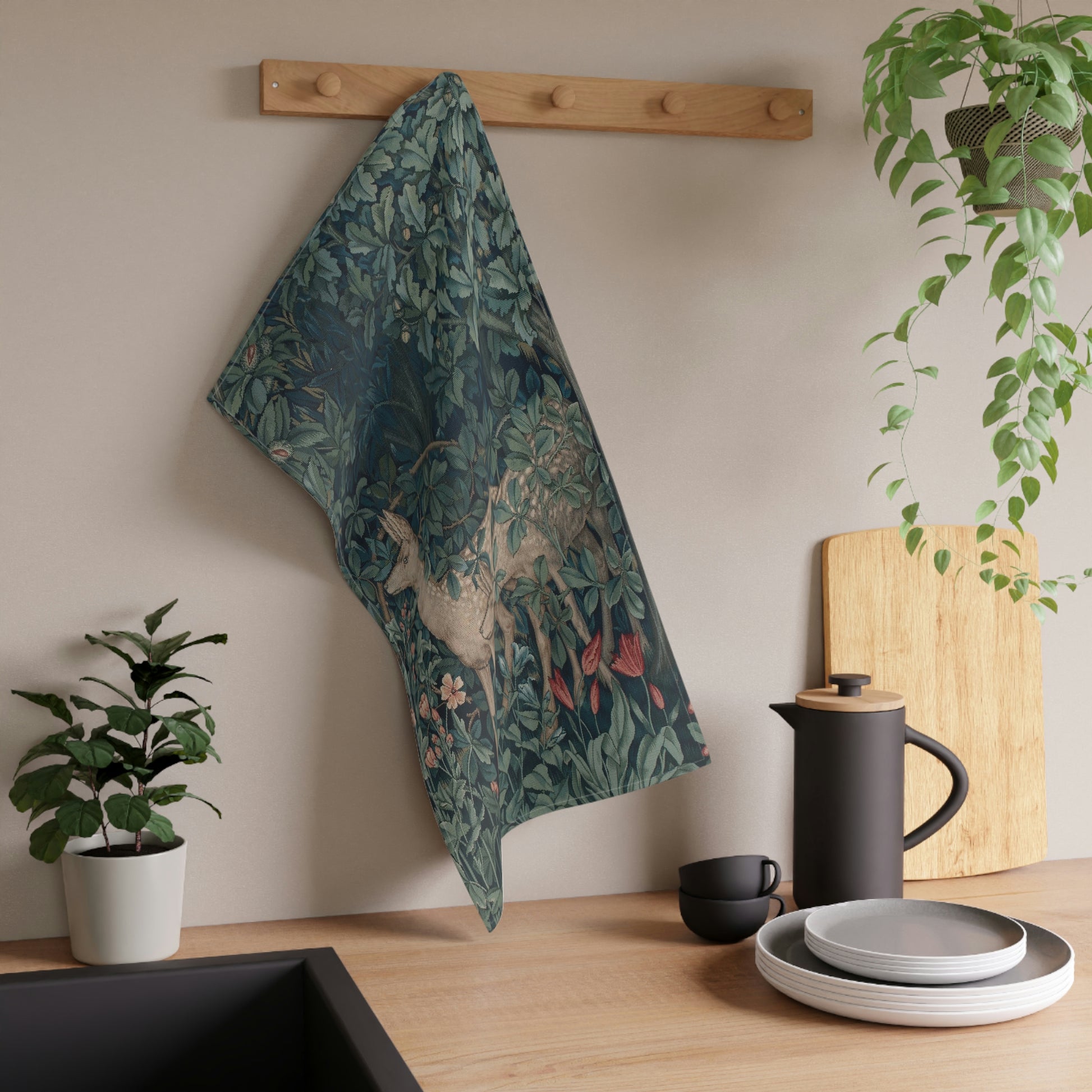 A kitchen tea towel featuring an artistic deer design with greenery and floral patterns inspired by William Morris - Greenery Collection.