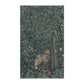 A kitchen tea towel featuring an artistic design with green foliage and a fox among the leaves.