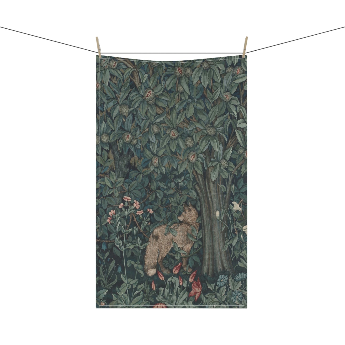 A kitchen tea towel featuring an artistic design with green foliage and a fox among the leaves.
