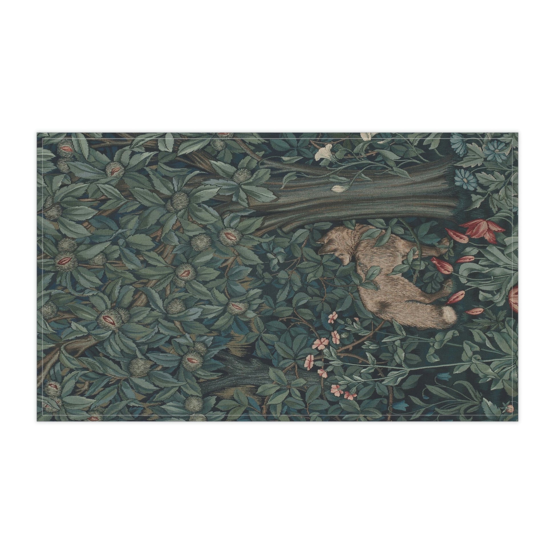 A kitchen tea towel featuring an artistic design with green foliage and a fox among the leaves.