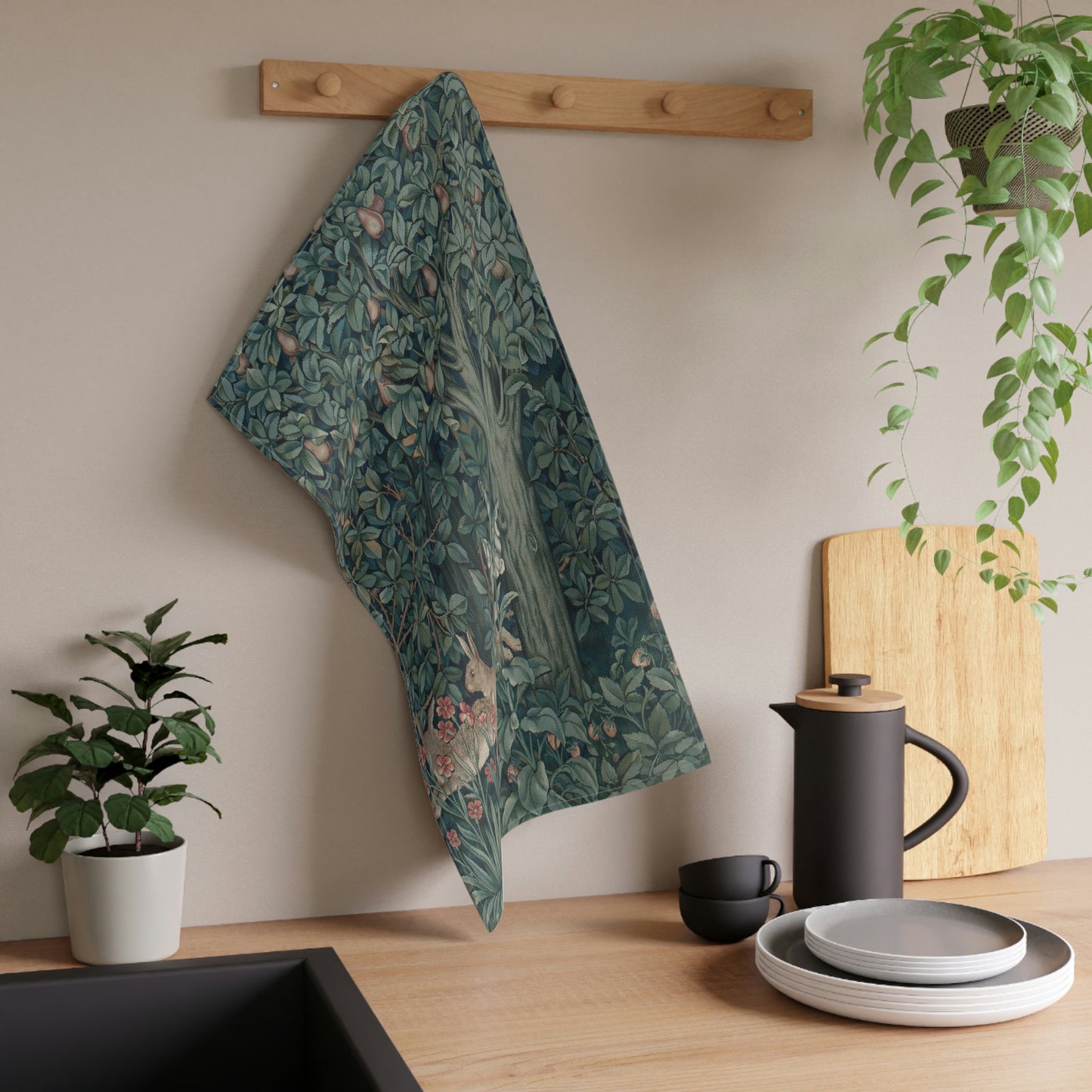 A kitchen tea towel featuring an artistic design with a rabbit among leaves and a tree, inspired by the William Morris - Greenery Collection.