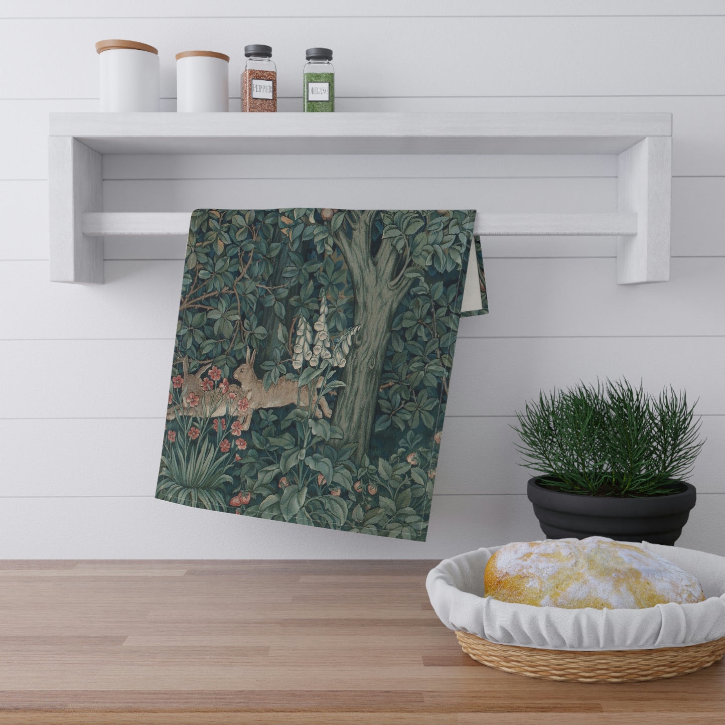 A kitchen tea towel featuring an artistic design with a rabbit among leaves and a tree, inspired by the William Morris - Greenery Collection.