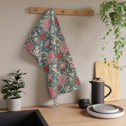 A kitchen tea towel with a floral pattern inspired by William Morris - Cray Collection, featuring predominantly blue, pink and red colours.