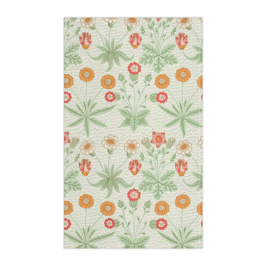 A kitchen tea towel featuring a floral William Morris & Co pattern with prominent orange and green colours on a white background.