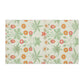 A kitchen tea towel featuring a floral William Morris & Co pattern with prominent orange and green colours on a white background.
