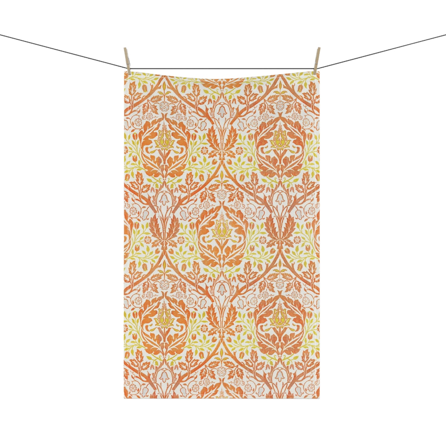 A kitchen tea towel with a floral William Morris  & Co pattern in orange, green, and yellow colours on a light background. 
