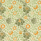A kitchen tea towel with a floral William Morris & Co pattern featuring green, orange and yellow colours on a light background.