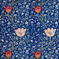 A kitchen tea towel with a blue background featuring William Morris & Co floral and geometric Art Nouveau patterns.