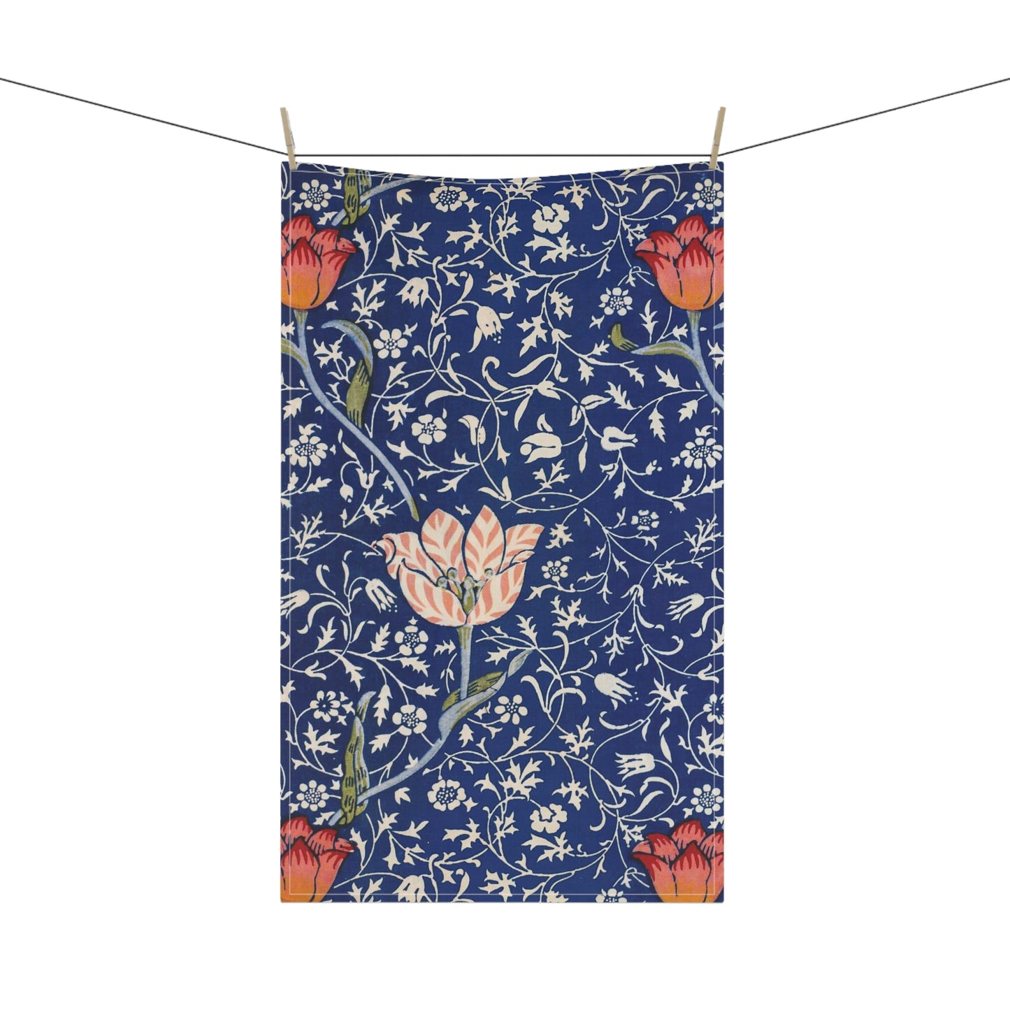 A kitchen tea towel with a blue background featuring William Morris & Co floral and geometric Art Nouveau patterns.