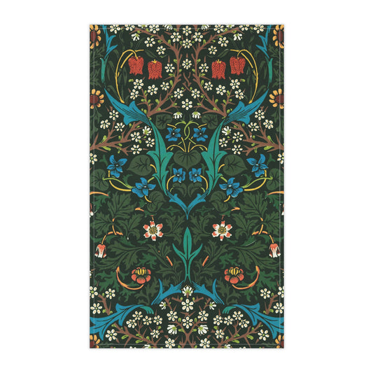A kitchen tea towel with a floral pattern inspired by William Morris, featuring tulips in red and blue on a dark green background.