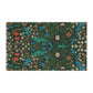 A kitchen tea towel with a floral pattern inspired by William Morris, featuring tulips in red and blue on a dark green background.
