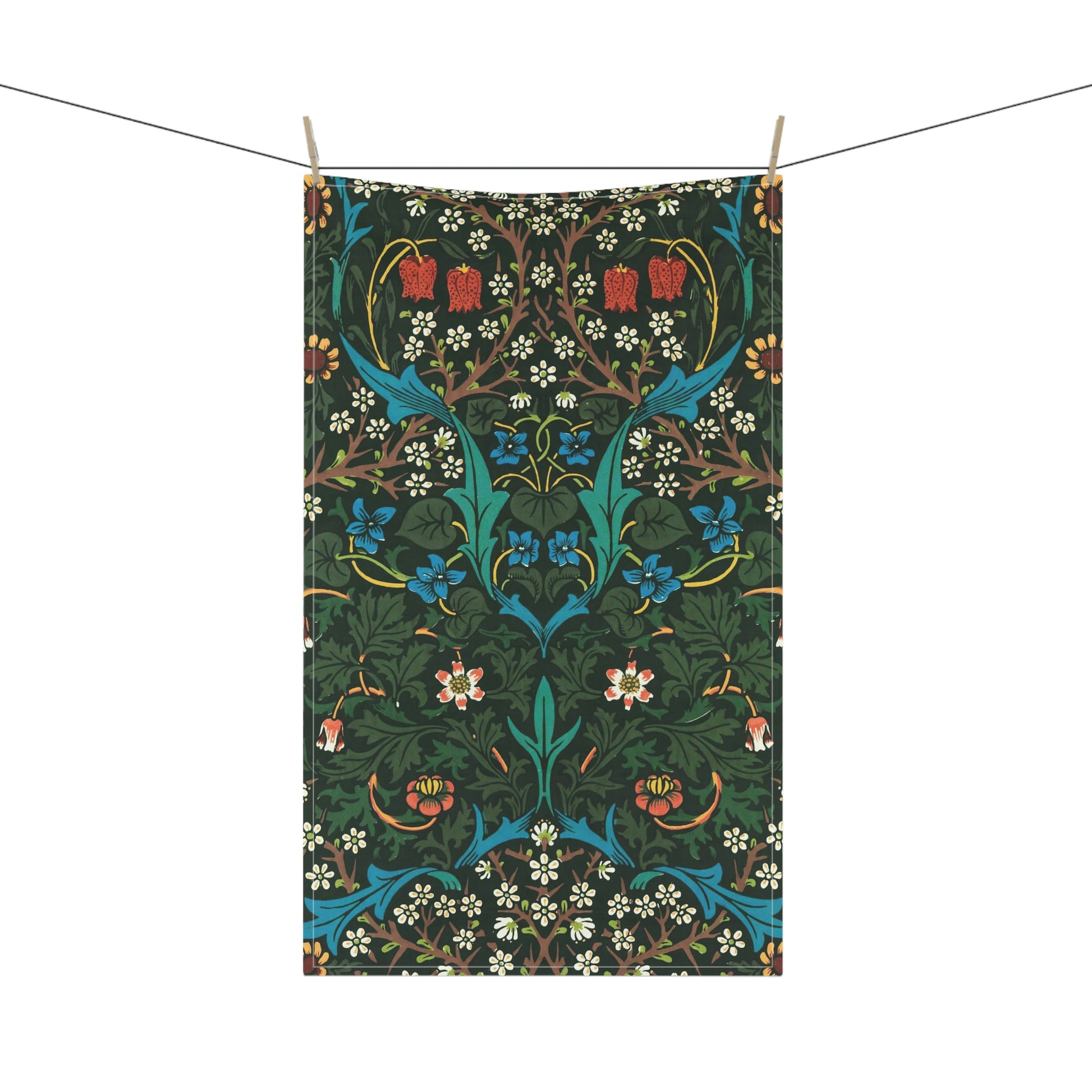 A kitchen tea towel with a floral pattern inspired by William Morris, featuring tulips in red and blue on a dark green background.