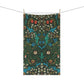 A kitchen tea towel with a floral pattern inspired by William Morris, featuring tulips in red and blue on a dark green background.