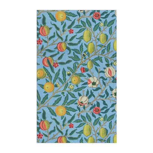 A kitchen tea towel with a blue background featuring a detailed floral and fruit pattern inspired by William Morris - Four Fruits Collection.