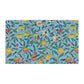 A kitchen tea towel with a blue background featuring a detailed floral and fruit pattern inspired by William Morris - Four Fruits Collection.