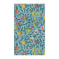 A kitchen tea towel with a blue background featuring a detailed floral and fruit pattern inspired by William Morris - Four Fruits Collection.