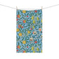 A kitchen tea towel with a blue background featuring a detailed floral and fruit pattern inspired by William Morris - Four Fruits Collection.