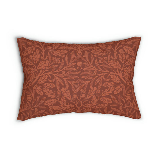 A rectangular lumbar cushion with a William Morris & CO floral pattern in a rust colour, featuring acorn and oak leaves, with a visible hidden zipper.