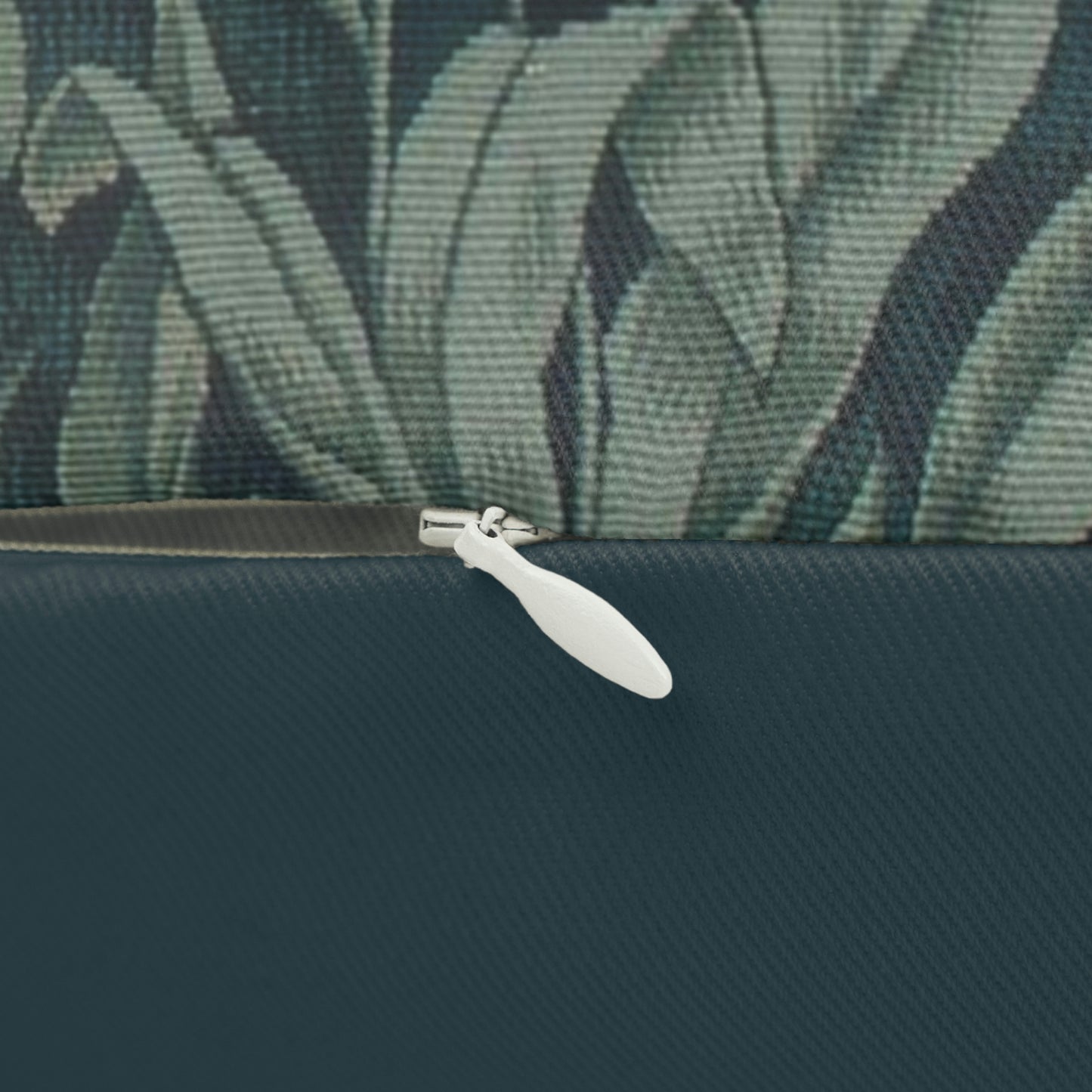 A lumbar cushion with a William Morris & Co floral and animal pattern, featuring a deer and tree in a garden setting.