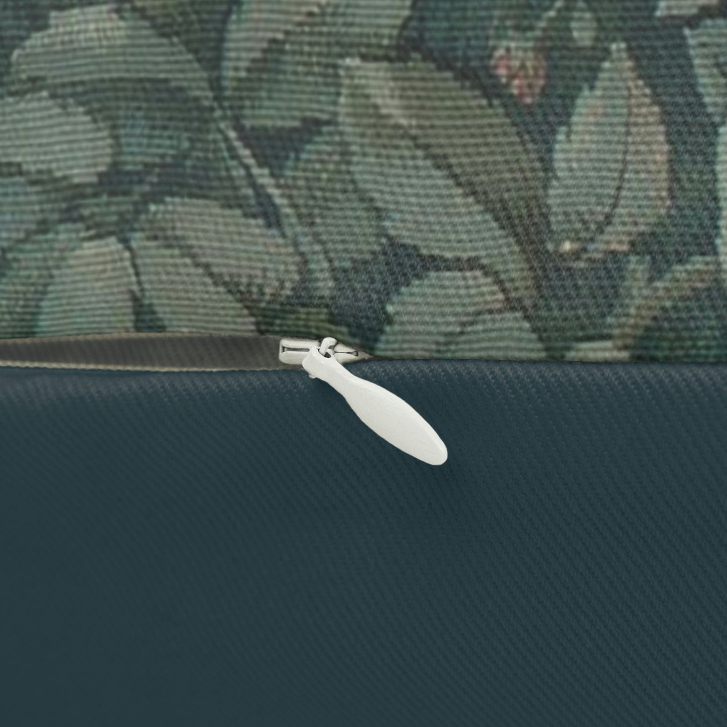 A rectangular lumbar cushion with a green and multicolour William Morris & Co floral and animal pattern design, featuring a rabbit and trees in the background.