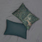 A rectangular lumbar cushion with a green and multicolour William Morris & Co floral and animal pattern design, featuring a rabbit and trees in the background.