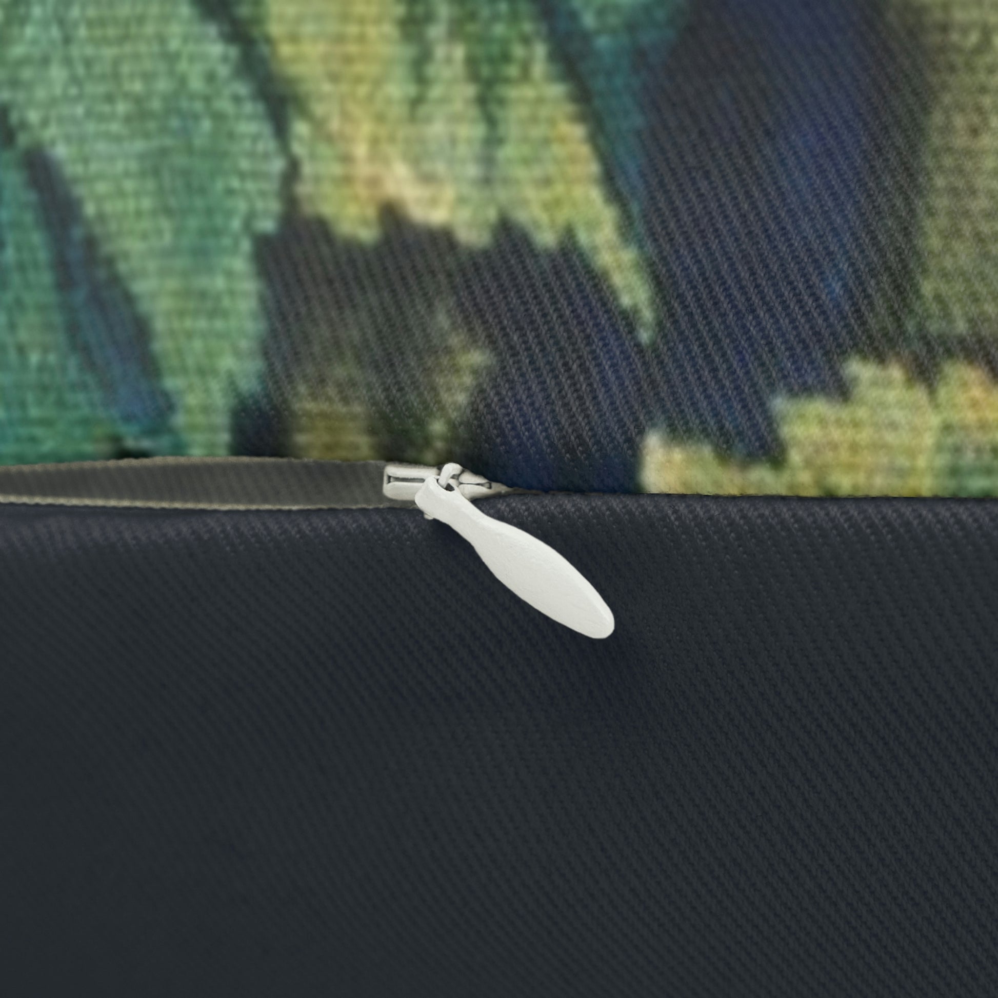 A lumbar cushion featuring a hidden beige zipper with a William Morris & Co design of a pheasant among green leaves on a background with a similar leaf pattern.