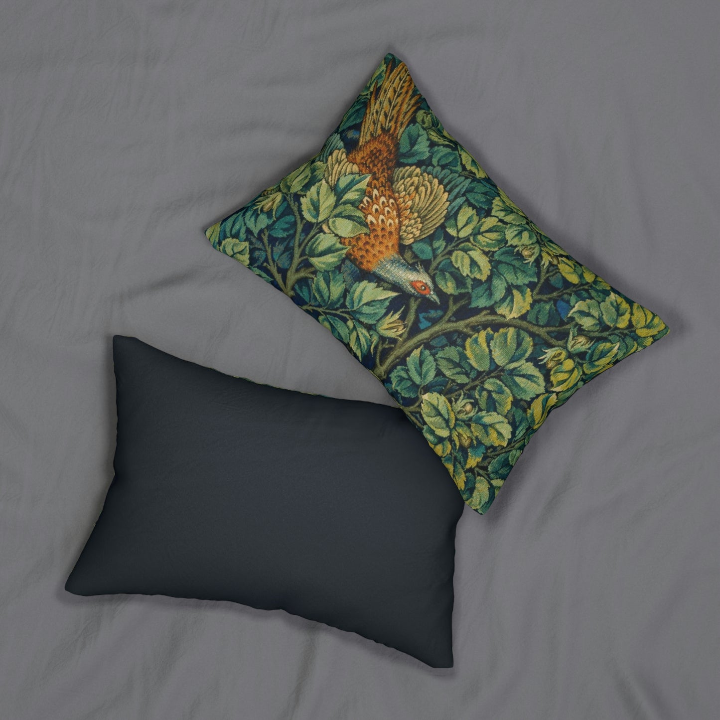 A lumbar cushion featuring a hidden beige zipper with a William Morris & Co design of a pheasant among green leaves on a background with a similar leaf pattern.