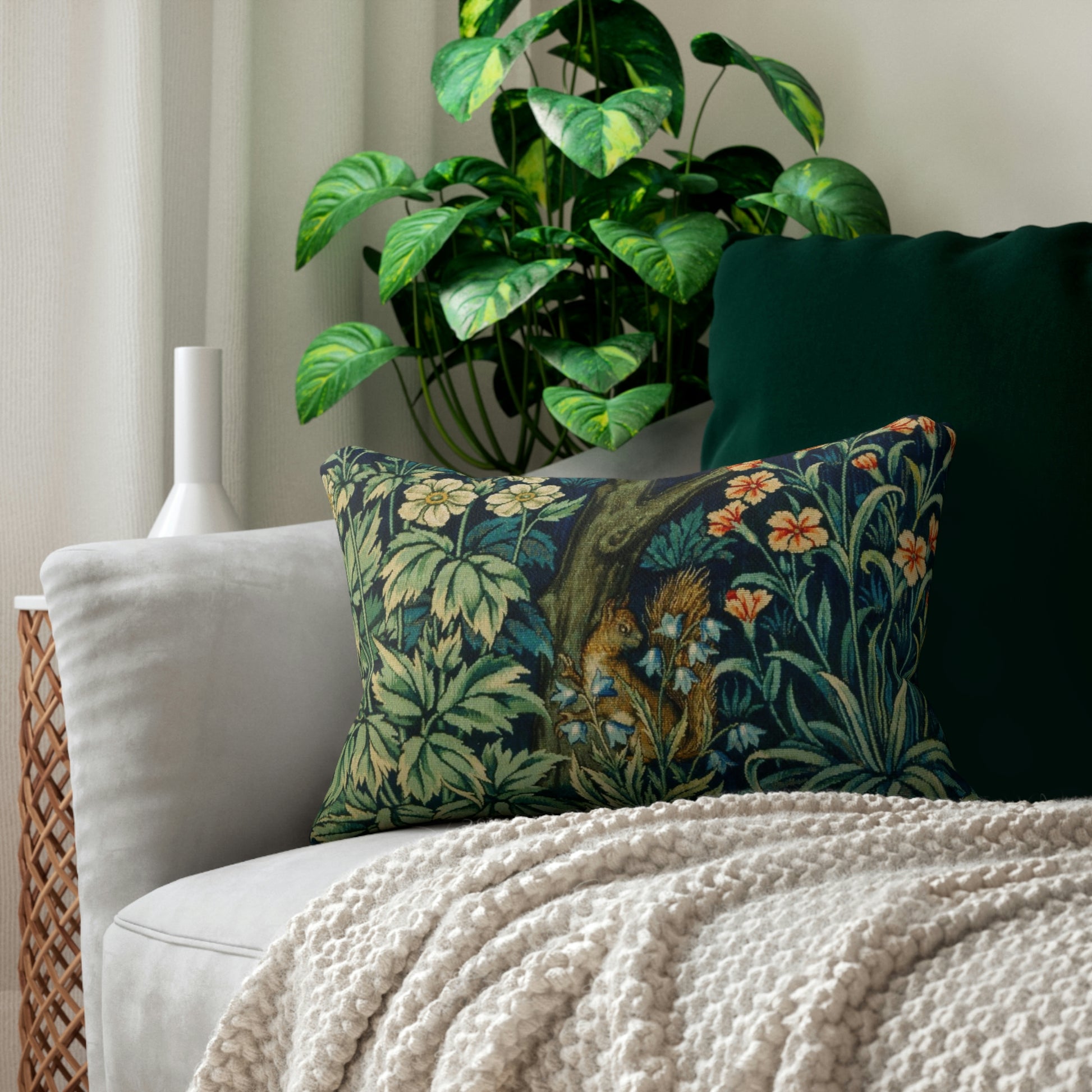 A lumbar cushion with a William Morris & Co floral and animal print design, featuring a tree and squirrel, on a white background.