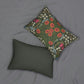 A rectangular lumbar cushion with a floral William Morris & Co pattern featuring predominantly green, with accents of red, yellow and blue.