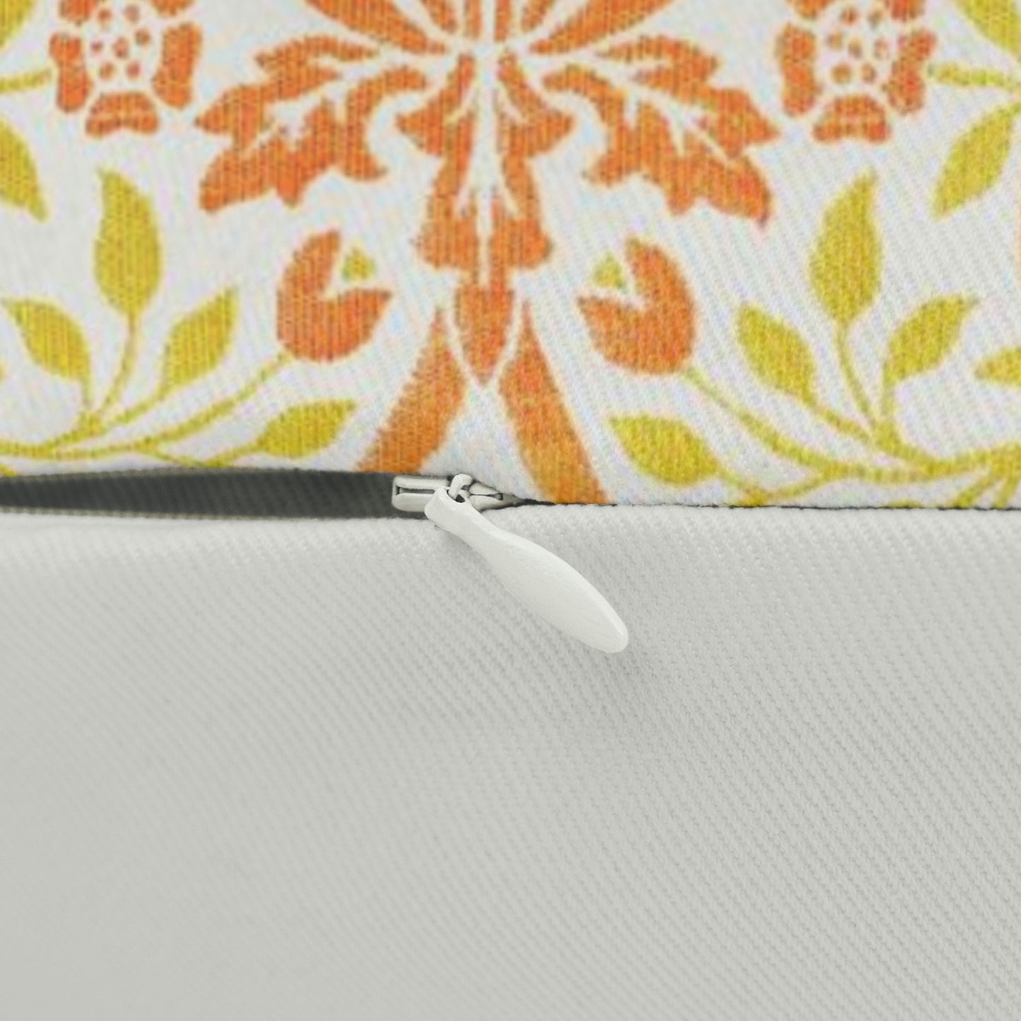 A rectangular lumbar cushion with a William Morris & Co floral pattern in shades of orange, beige, and yellow, featuring a concealed zipper.