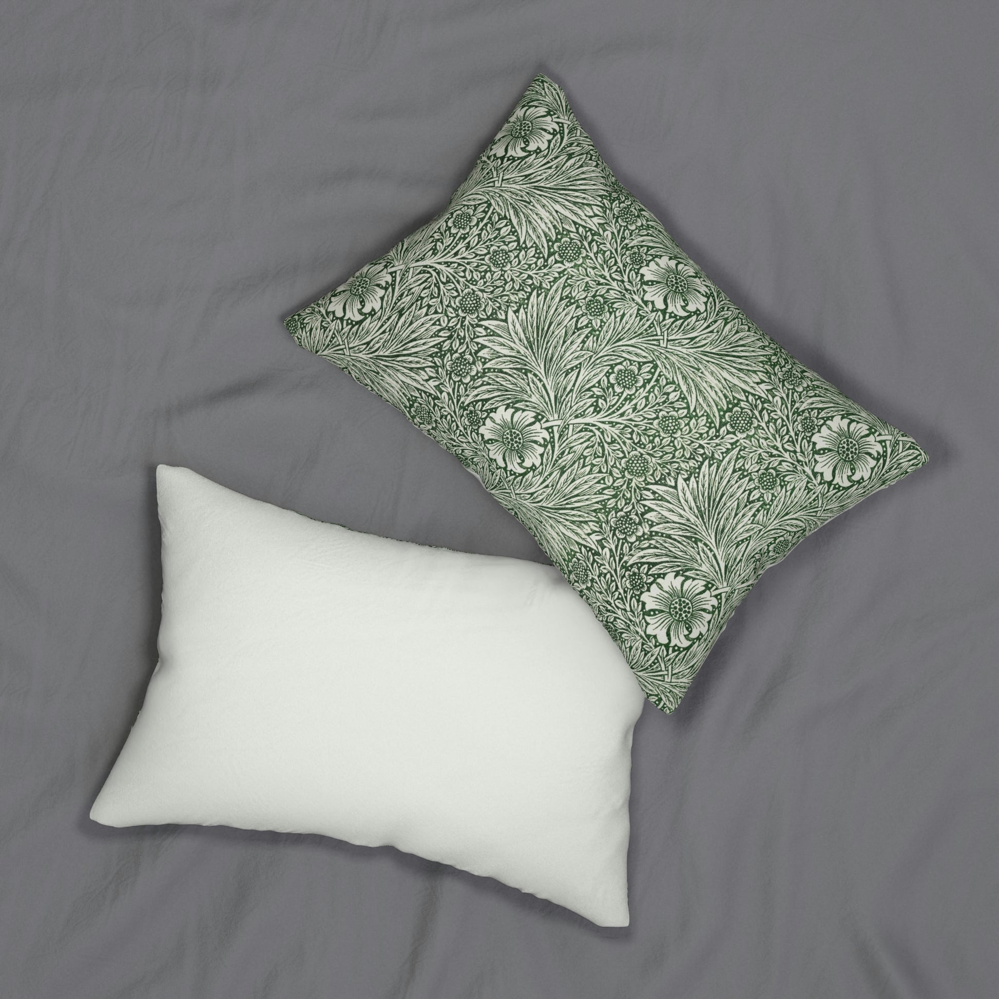 A rectangular lumbar cushion with a green William Morris & Co floral pattern on a white background, featuring a concealed beige zipper.