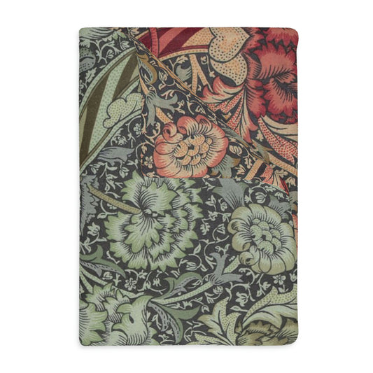 A rectangular blanket with a two-sided print featuring intricate floral designs and a minky soft velveteen texture.