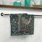 A white washcloth with a floral pattern inspired by William Morris, featuring deer and greenery.