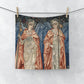 A white washcloth with a printed floral pattern inspired by William Morris, featuring two angels in a vintage style.